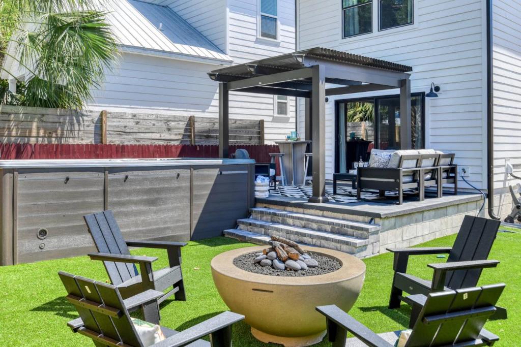 a backyard with a fire pit and a gazebo at Lincolnville Nook in St. Augustine