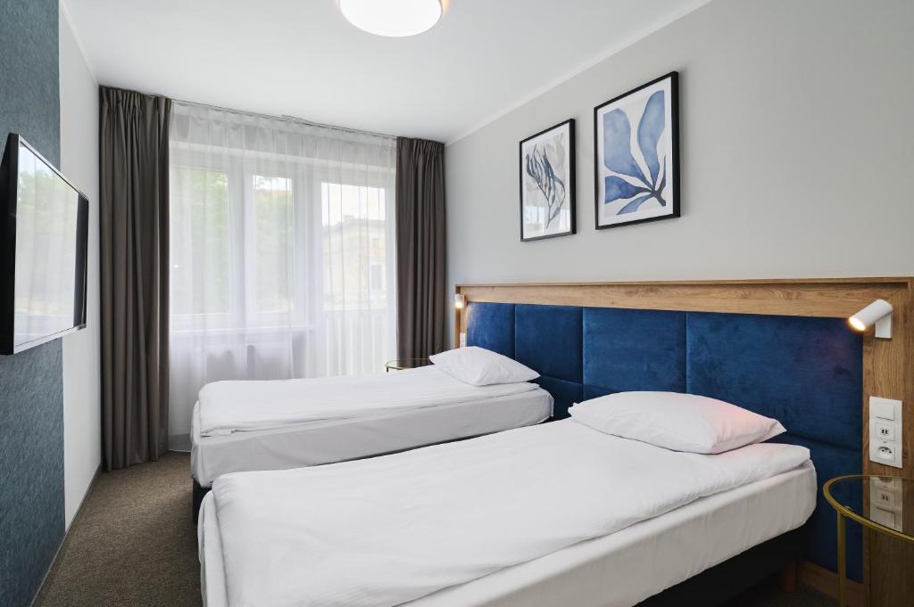 Postel nebo postele na pokoji v ubytování Hotel Halo Toruń