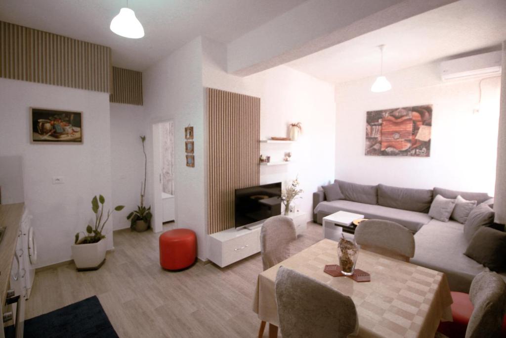a living room with a couch and a table at Arber's Home in Sarandë