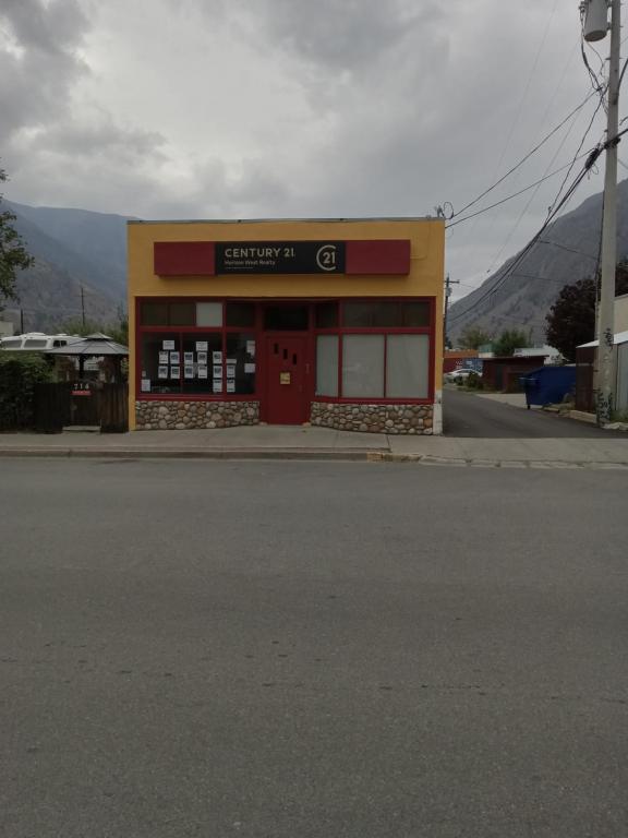 a store with a red door on the side of a street at Luisa's guest suite in Keremeos