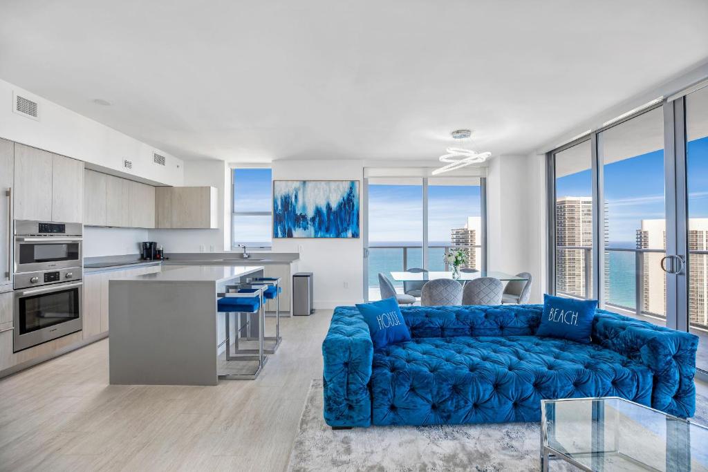a living room with a blue couch in a kitchen at HYDE BEACH HOUSE - MILLIONAIRE 2 bd 2 ba APT, DIRECT OCEAN VIEW, 5 MIN WALK TO OCEAN in Hollywood