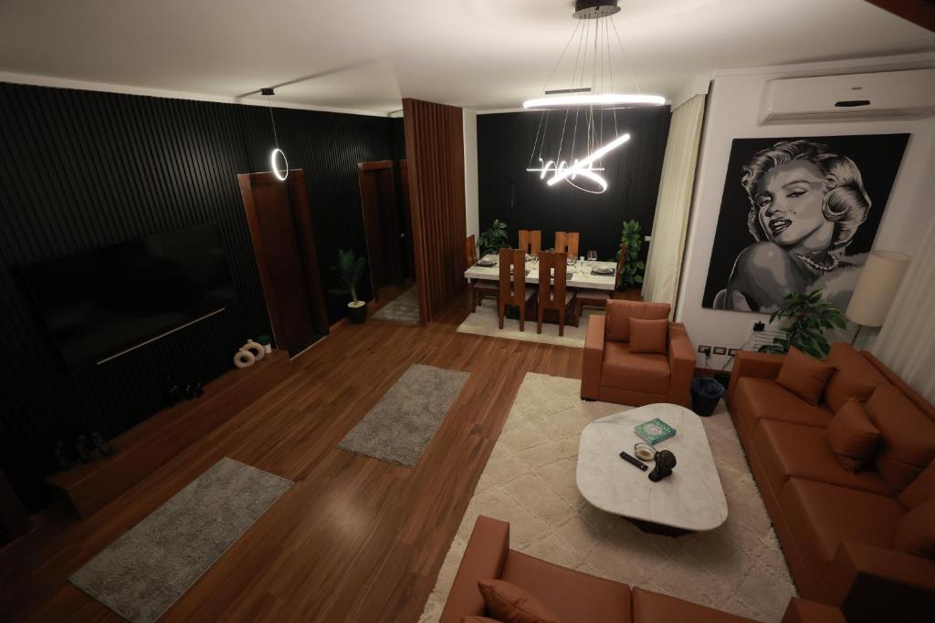 a living room with a couch and a table at The Palm Terrace Penthouse 3BR - Palm Hills - 280 sqm in Cairo
