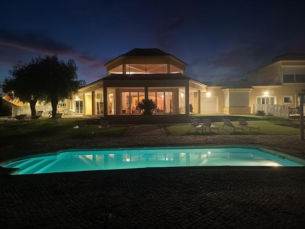 a house with a swimming pool at night at Herdade do Montinho in Portalegre
