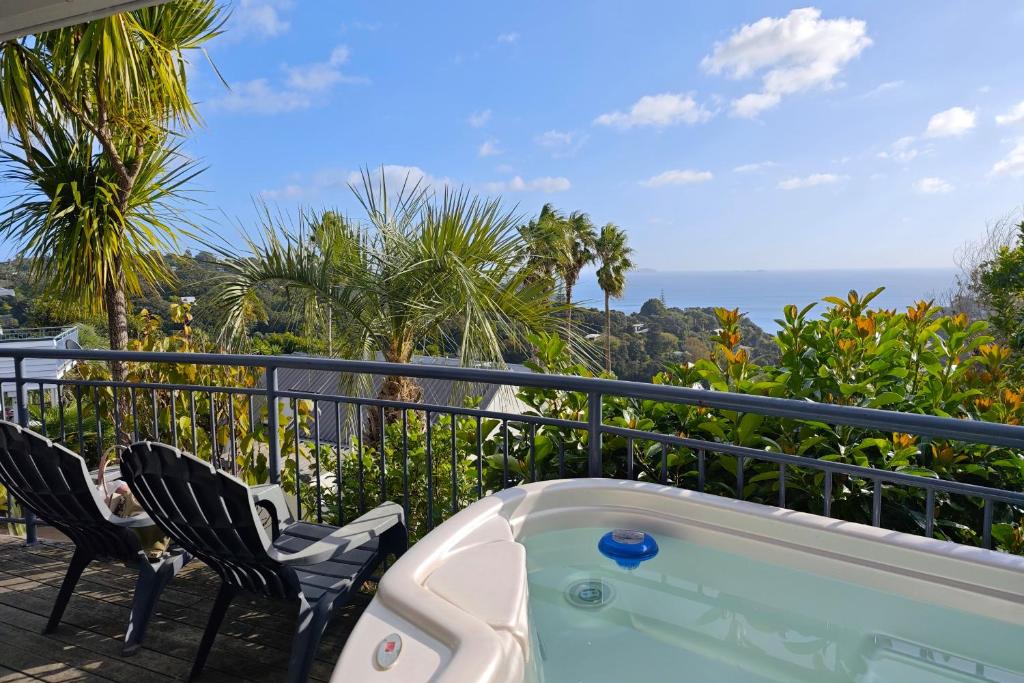 a hot tub on a balcony with two chairs at Palm Beach Perfection SPA Pool Free WIFI in Palm Beach