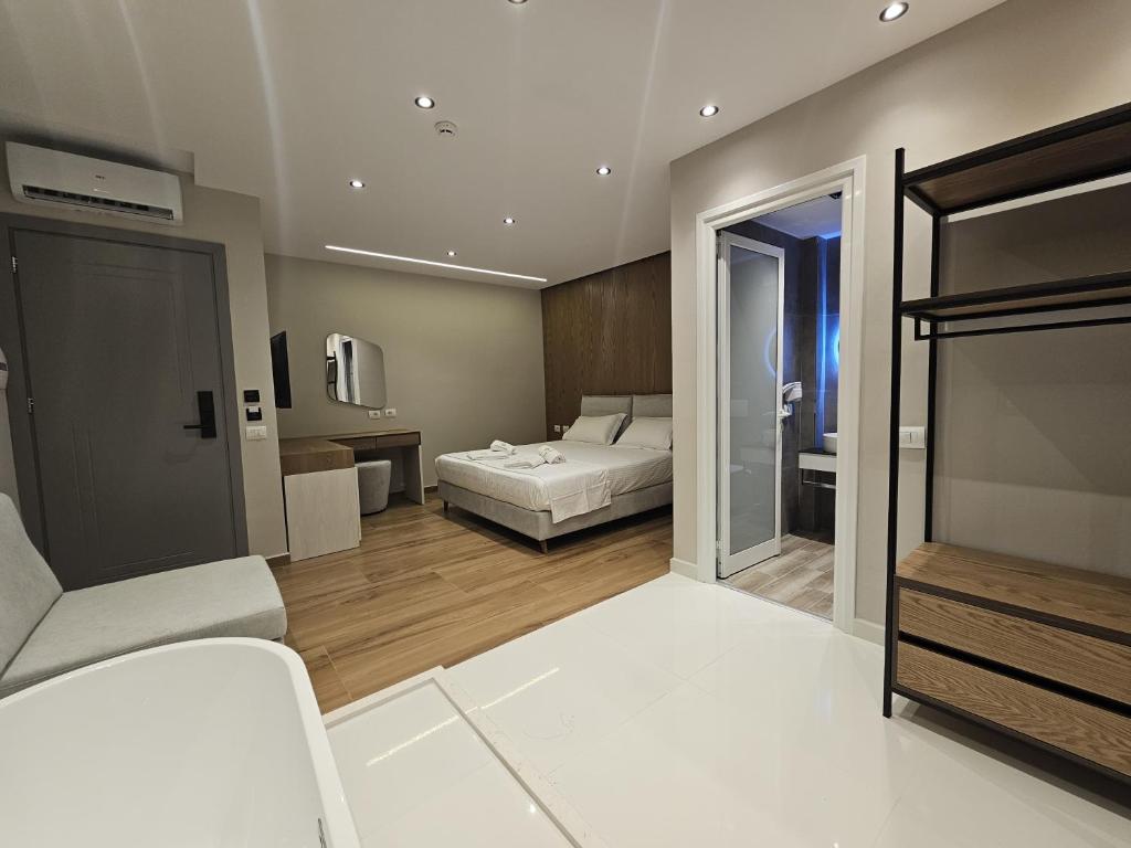 a bedroom with a bed and a living room at Diol Hotel Ksamil in Ksamil