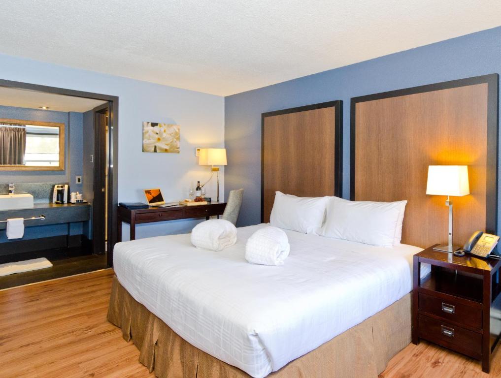 a hotel room with a bed and a desk at Centro Motel in Calgary