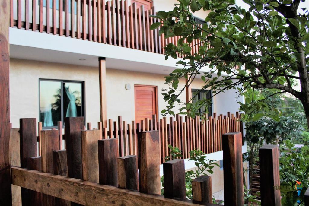 a wooden fence in front of a house at Túumben Ché Departamento 7 in Valladolid