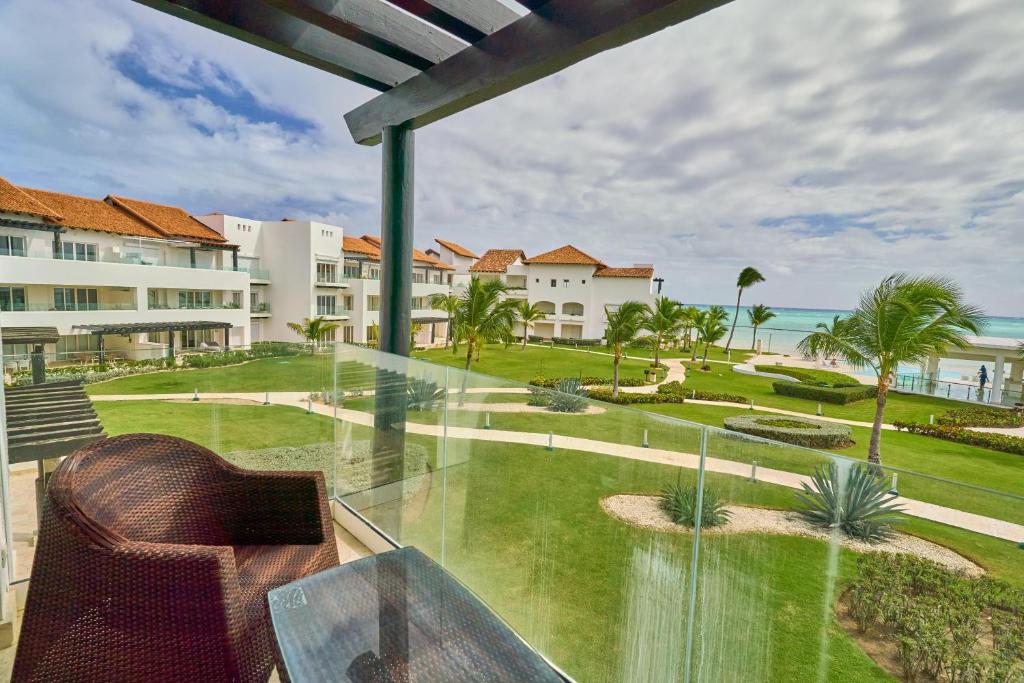 a glass balcony with a view of the ocean at Beautiful Modern Studio At Cap Cana, Punta Cana in Punta Cana