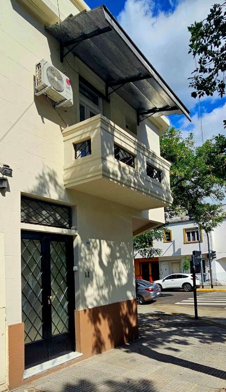 a building with a balcony on the side of it at Nelly's Apartment in Buenos Aires