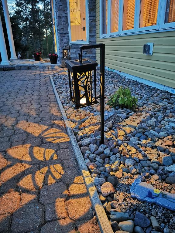 a trash can sitting in front of a house at 181 Oceanside Inn in Peggy's Cove