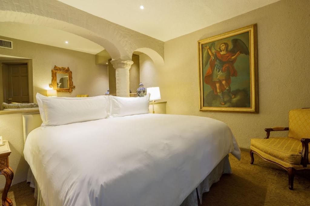Postel nebo postele na pokoji v ubytování Quinta Real Guadalajara