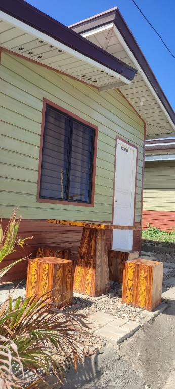 a house with two logs in front of it at Olango Transient Home,with WIFI &Netfix in Santa Rosa
