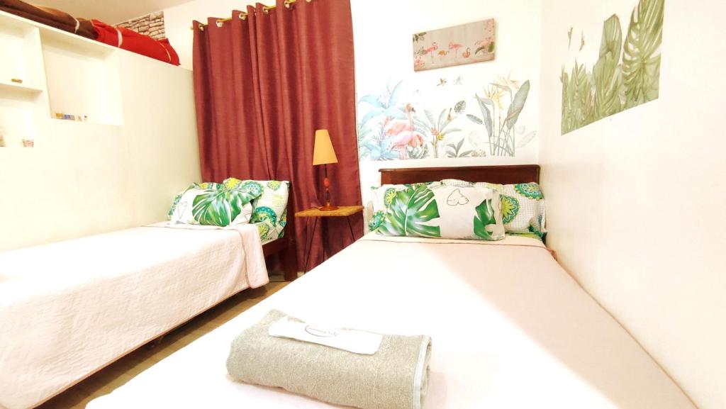 a bedroom with two beds and a lamp at Olango Transient Home,with WIFI &Netfix in Santa Rosa