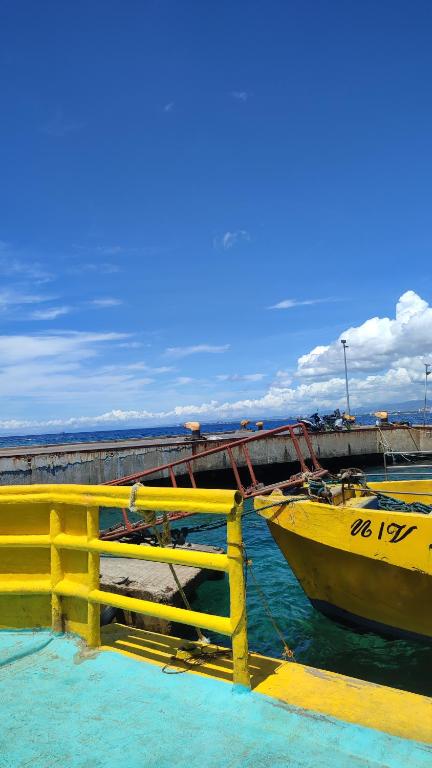 a yellow boat in the water next to a pier at Olango Transient Home,with WIFI &Netfix in Santa Rosa