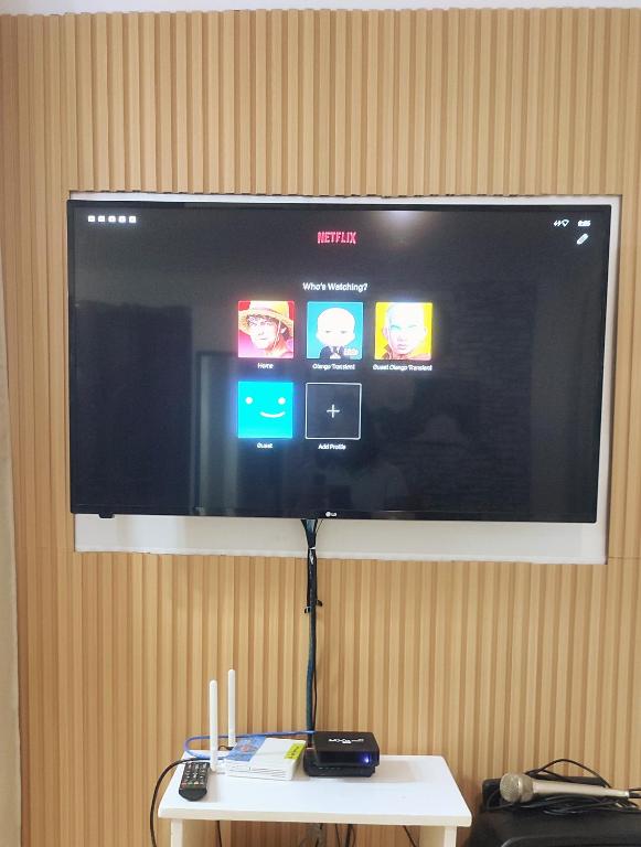 a flat screen tv hanging on a wall at Olango Transient Home,with WIFI &Netfix in Santa Rosa