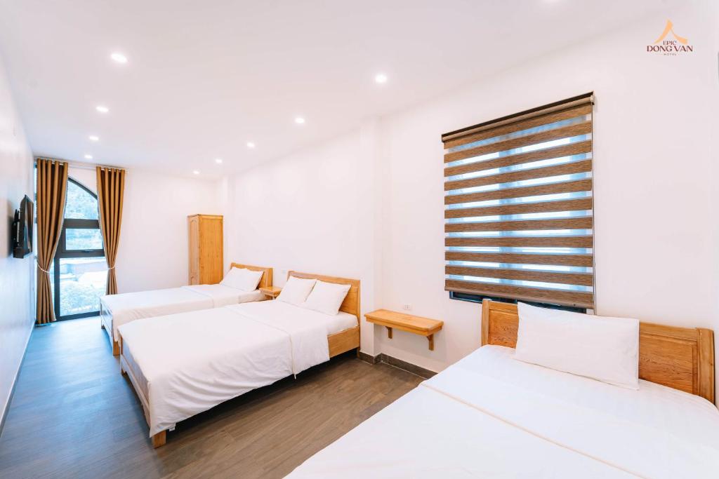 Postel nebo postele na pokoji v ubytování Epic Đồng Văn Hotel