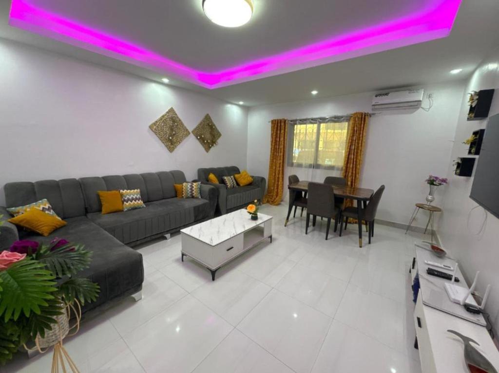 a living room with a couch and a table at Appartemennt meuble nirvana in Dakar