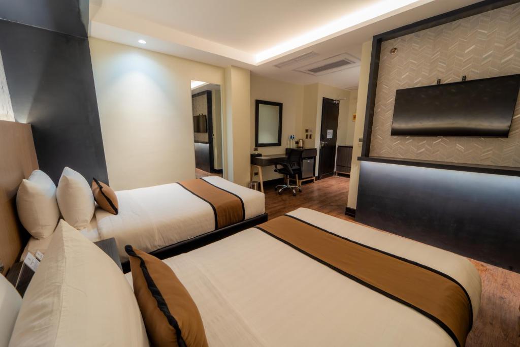 Postel nebo postele na pokoji v ubytování MetroCentre Hotel