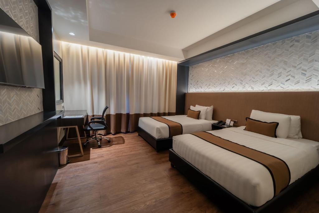 Postel nebo postele na pokoji v ubytování MetroCentre Hotel