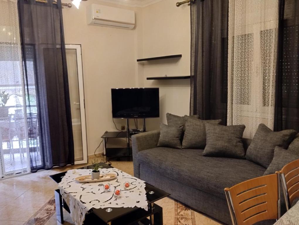 a living room with a couch and a table at Linda's apartment in Agia Triada