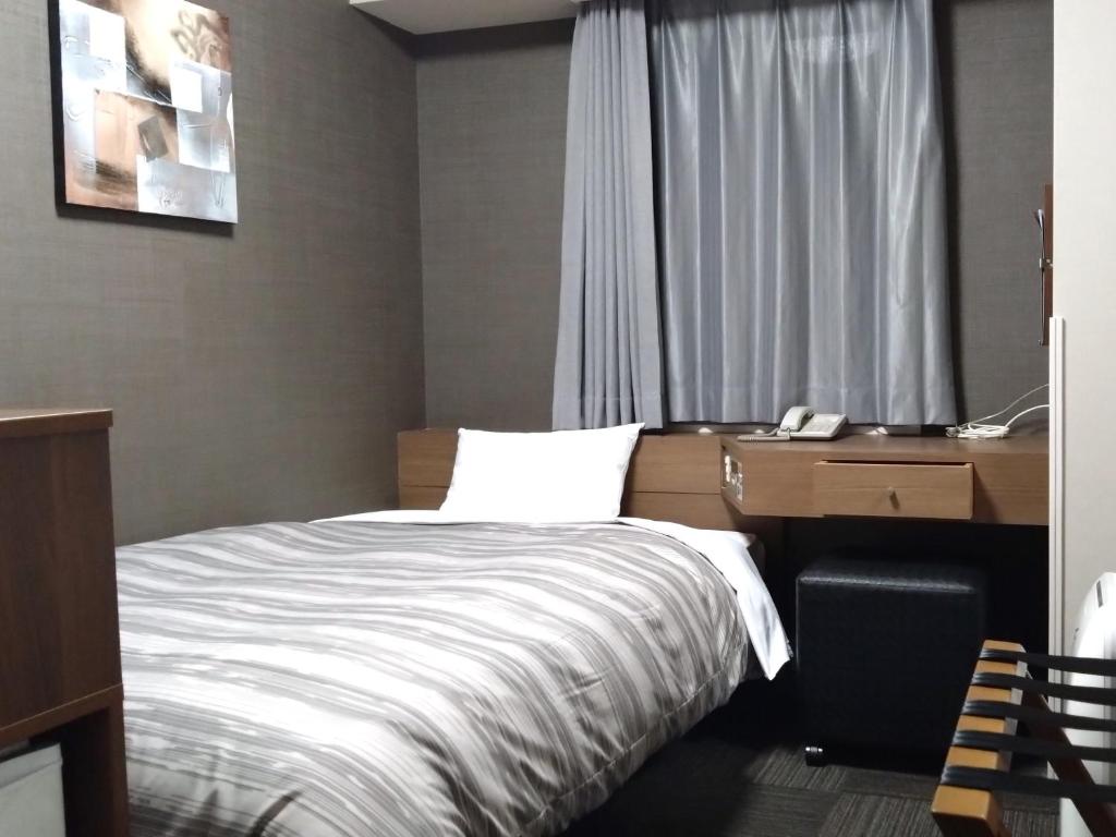 Postel nebo postele na pokoji v ubytování Hotel Route-Inn Hitachitaga