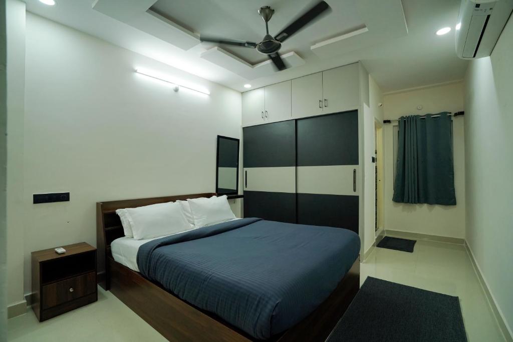 a bedroom with a bed and a ceiling fan at N Cube Serviced Apartments in Hyderabad