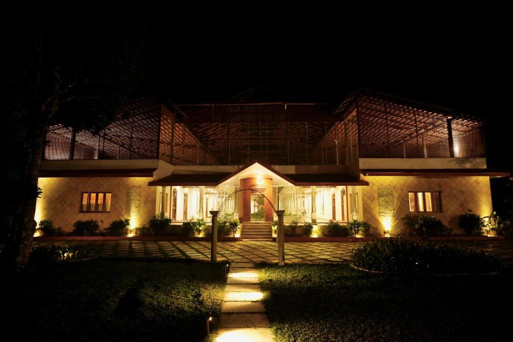 a house at night with lights in front of it at The Windchimes Retreat Coorg in Virajpet