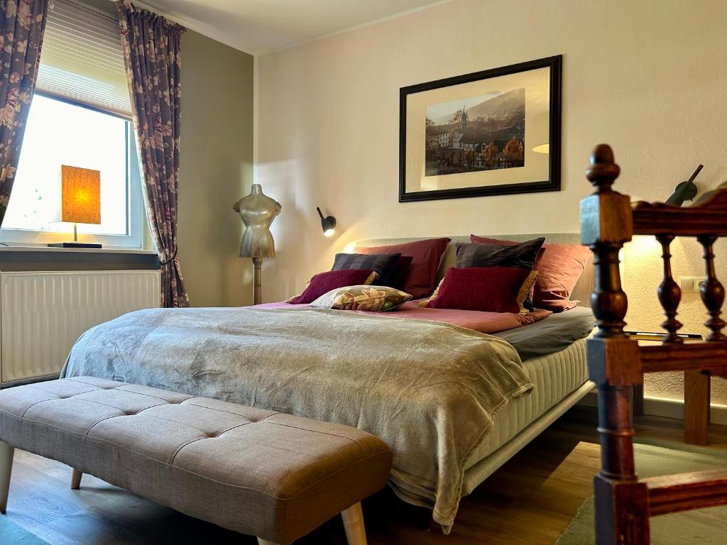 a bedroom with a large bed and a window at Villa Pauline - FeWo “Provence“ in Bad Sooden-Allendorf