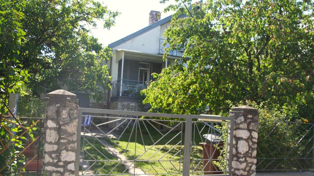 a fence in front of a house with a gate at Madarász 7 Deluxe Vendégház in Balatonalmádi