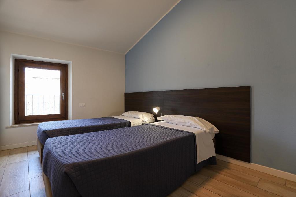 Postel nebo postele na pokoji v ubytování Le Querce Apartments