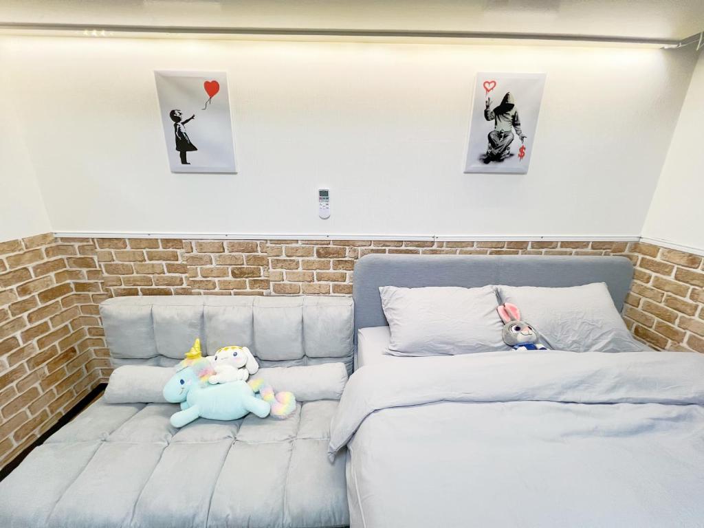 东京Ikebukuro Sugamo 最大4人B5的两个塞满食物的动物坐在卧室的床上