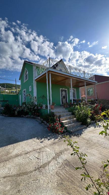 a house with stairs and flowers in front of it at VILLA MEYSARY in Shamakhi
