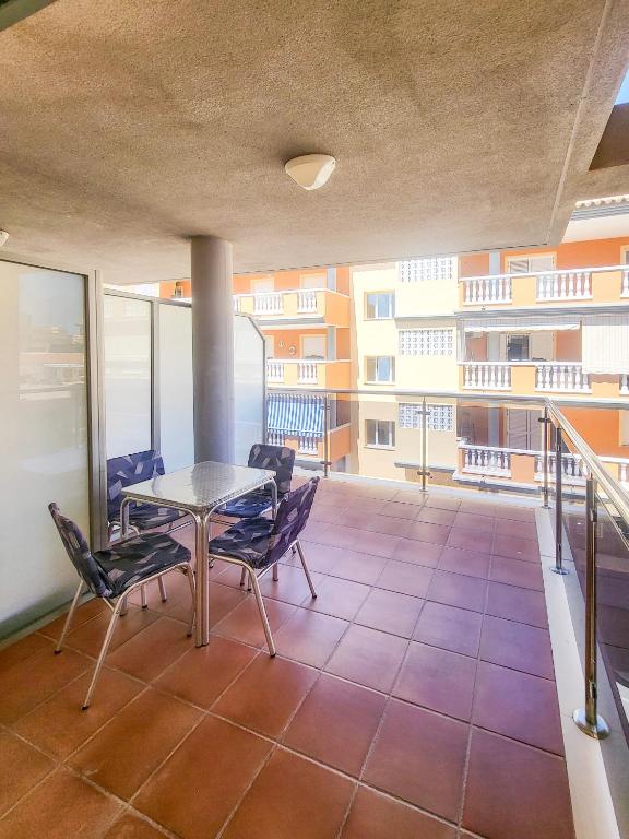 a balcony with a table and chairs in a building at Las Jarcias 2C in Moncófar