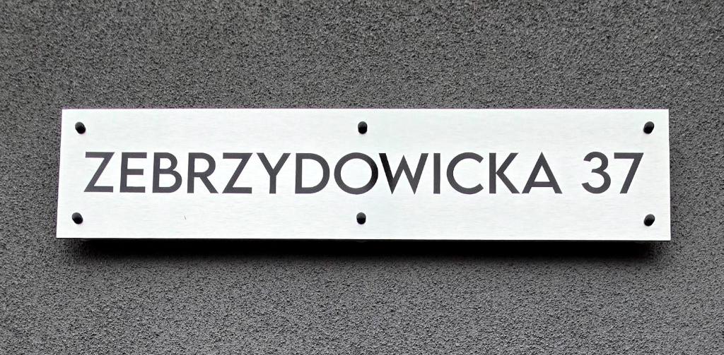 a white sign on a wall with the word zaporizia at Zebrzydowicka 37 in Rybnik