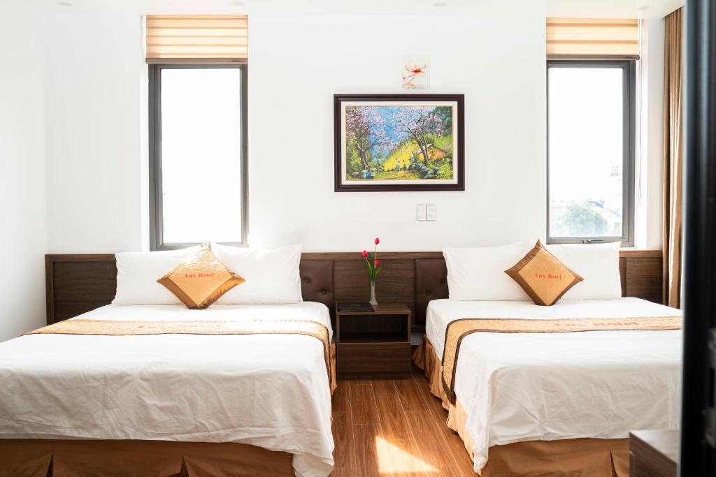 Ένα ή περισσότερα κρεβάτια σε δωμάτιο στο Lux Hotel FLC Sầm Sơn