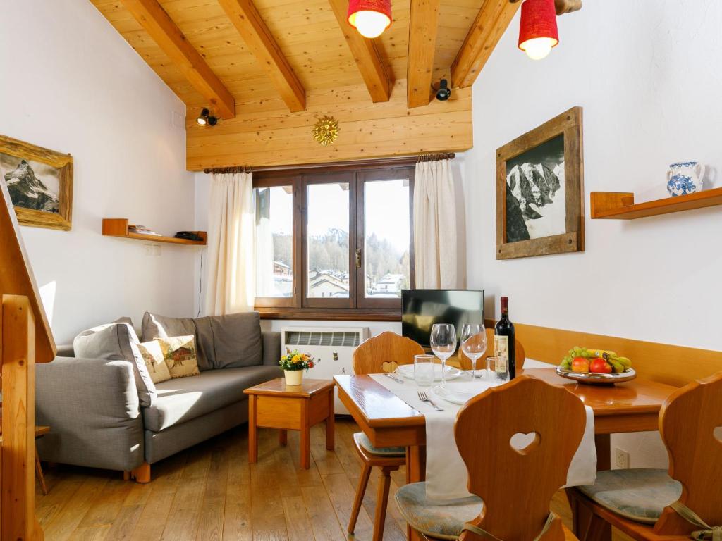 a living room with a couch and a table at Apartment Residenza Chesa Margun 59-4 by Interhome in Surlej