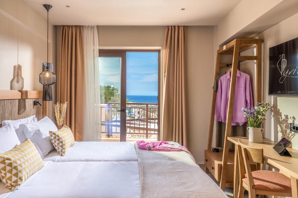 a hotel room with a bed and a balcony at Hotel Pyriá in Hersonissos