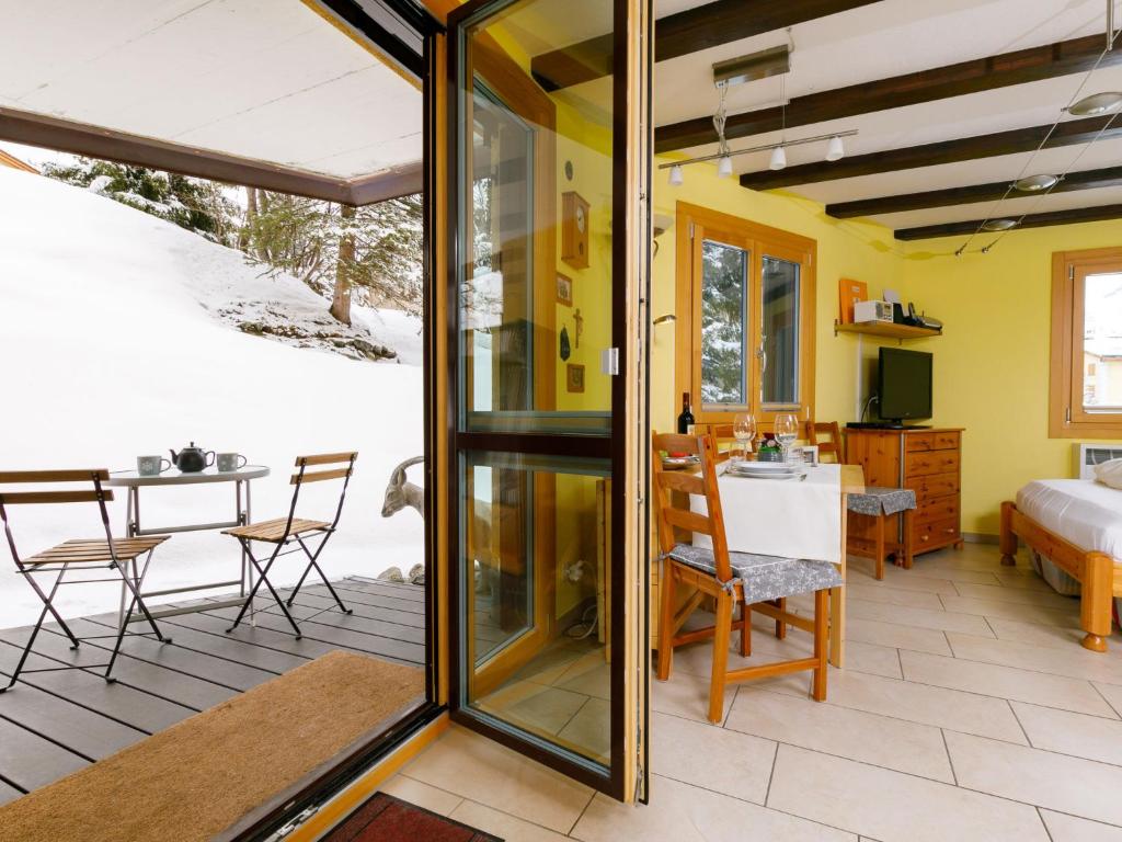 a room with a patio with a table and chairs at Apartment Residenza Chesa Margun 34-6 by Interhome in Surlej