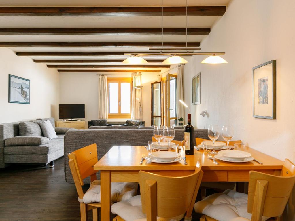 a living room with a table and chairs and a couch at Apartment Residenza Chesa Margun 79-3 by Interhome in Surlej