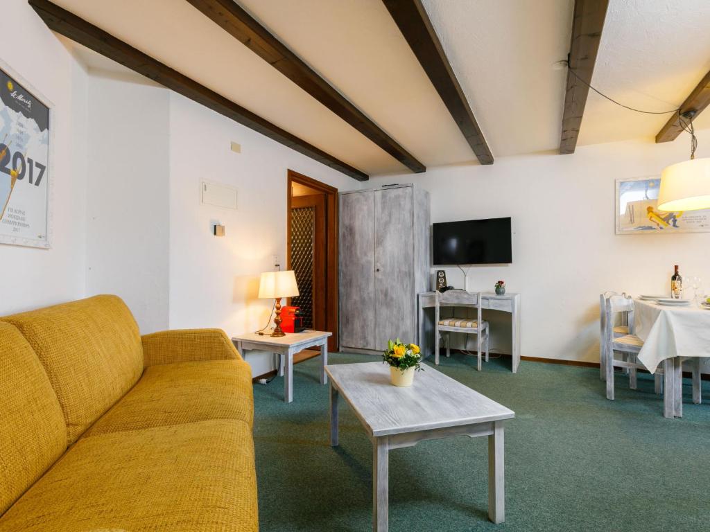 a living room with a couch and a table at Apartment Residenza Chesa Margun 13-6 by Interhome in Surlej