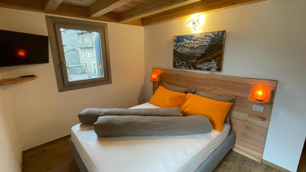 Postel nebo postele na pokoji v ubytování beb Aria di Montagna