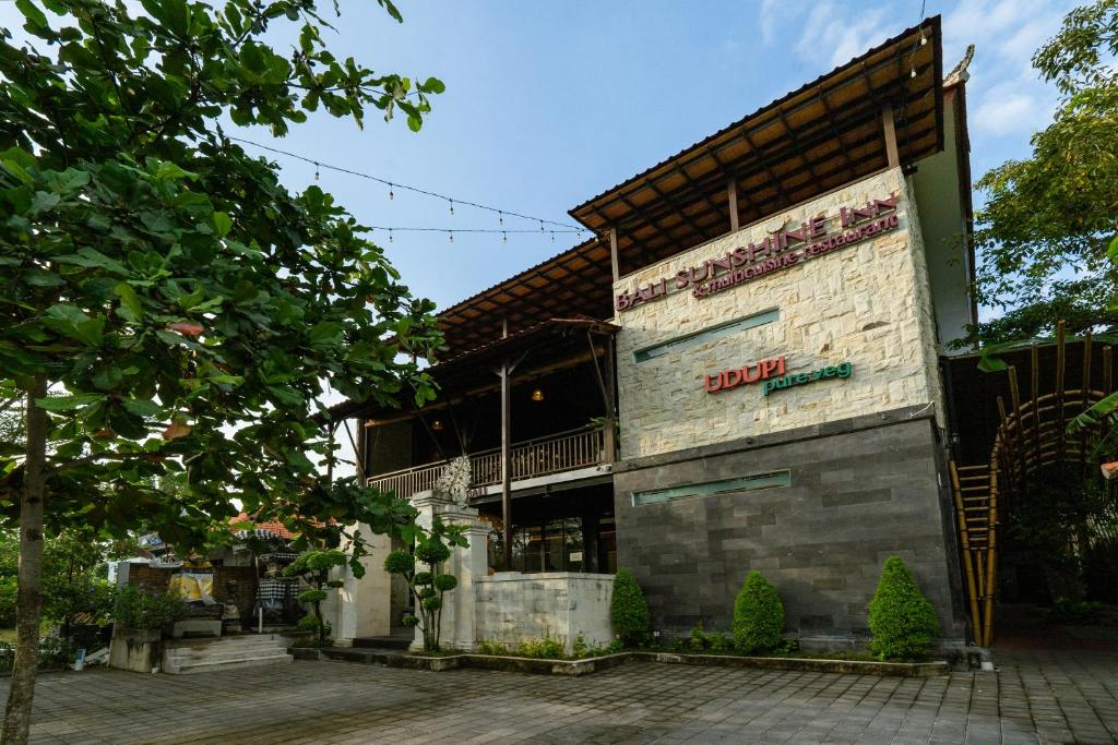 a building with a sign on the side of it at Bali Sunshine Nusa Dua in Nusa Dua