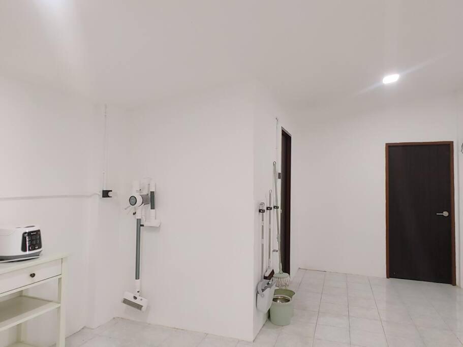 a room with white walls and a black door at 辉煌夜市 4房泳池花园别墅 订4日提供免费接机 in Ban Na Song