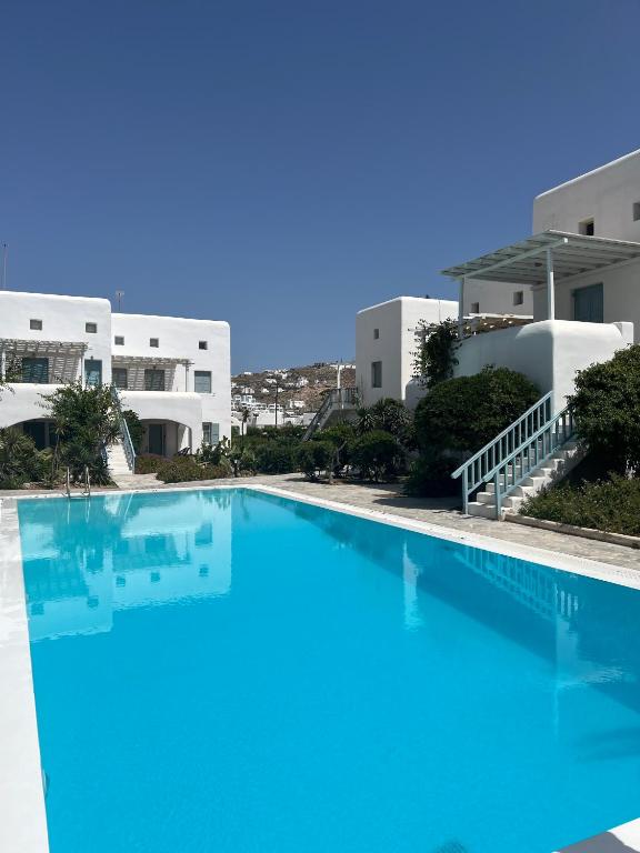 a large swimming pool in front of a building at Mykonos Summer House in Mikonos