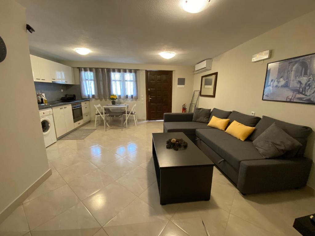 a living room with a couch and a table at Aldebaran house in Nea Fokea