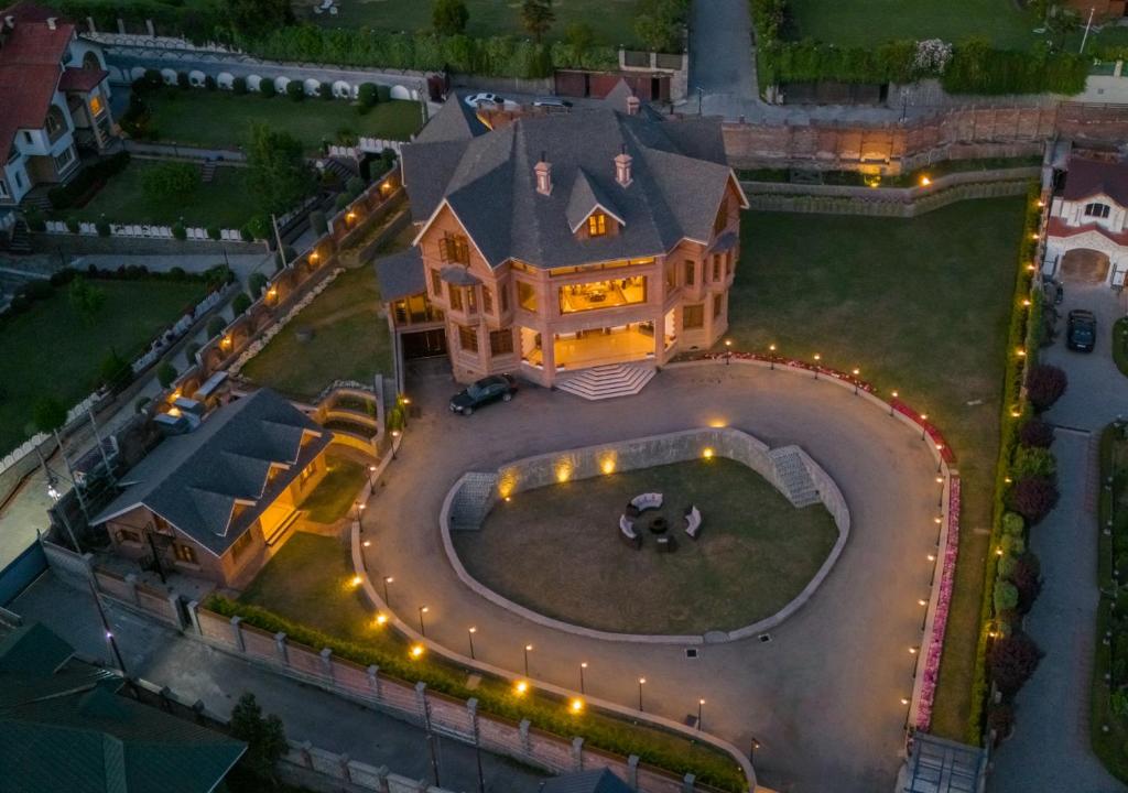 an aerial view of a large house with lights on it at Lohono Stays Villa Noor in Srinagar