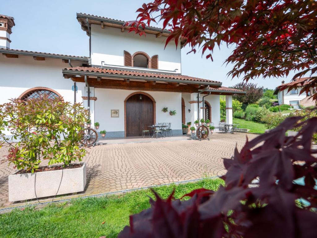 a house with a courtyard in front of it at Holiday Home Collina San Ponzio by Interhome in Barolo