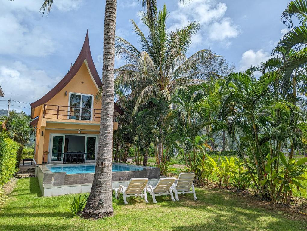 a house with a swimming pool and palm trees at Villa with Private Pool - by KohChangVillas in Ko Chang