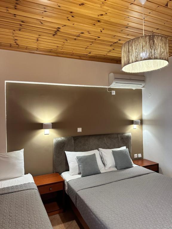 a bedroom with two beds and a ceiling at Semiramis in Lefkada Town
