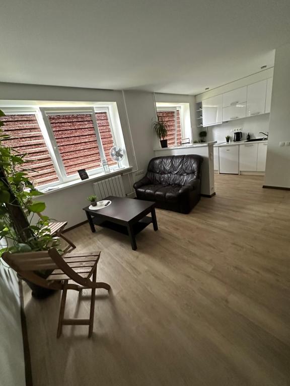 a living room with a couch and a table at Studio apartment in Valmiera